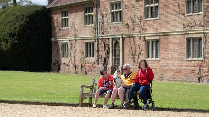 Visitors on a bench on the front drive at Blickling Estate